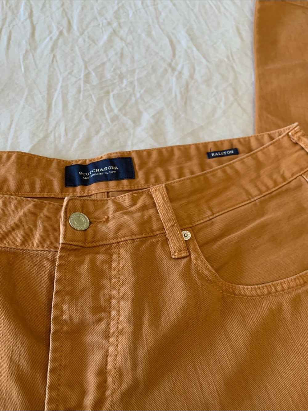 Scotch & Soda Ralston jeans in a rust color.